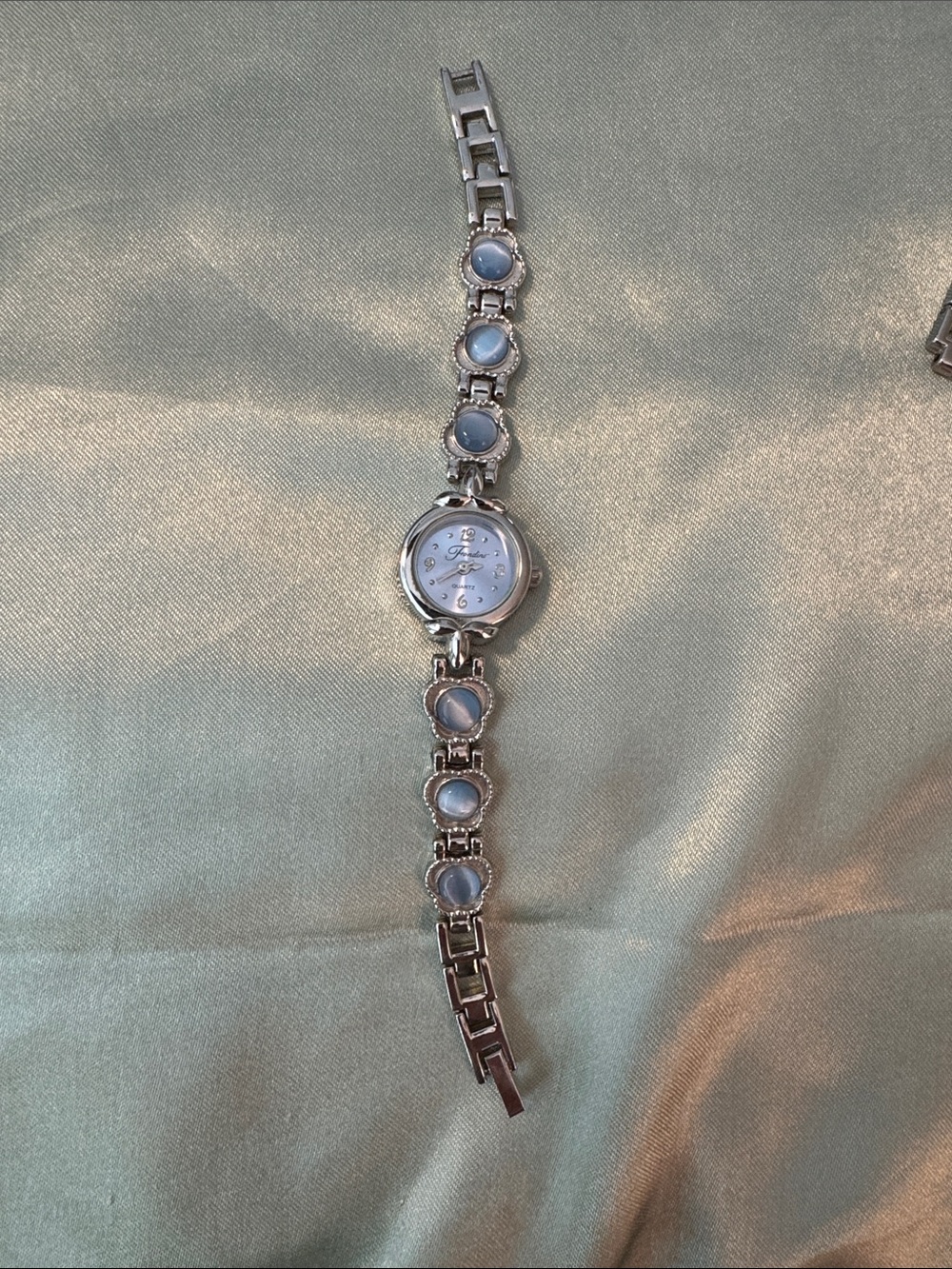 Fondini Silver Tone Women's Bracelet Watch with Light Blue Accents.